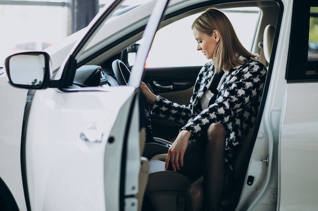 Young business woman choosing a car