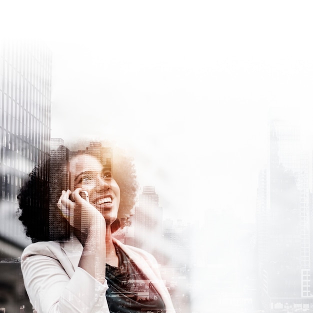 Young business woman on phone over city background