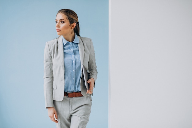 Young business woman standing in the office isolated