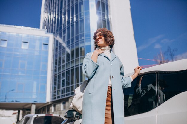 Young business woman travelling by electro car