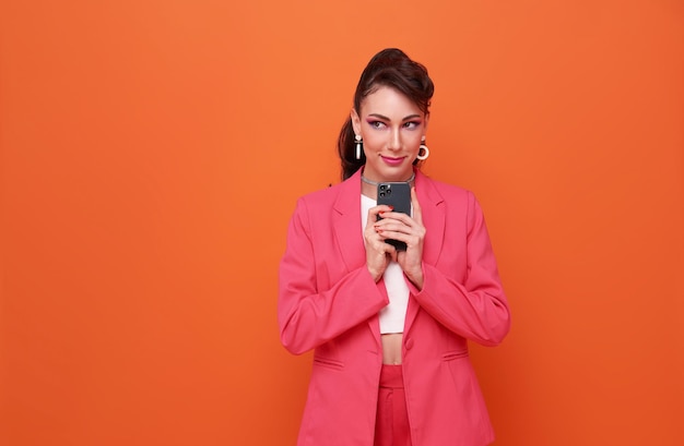 Young business woman using mobile cell phone ponders on how to answer question thinks