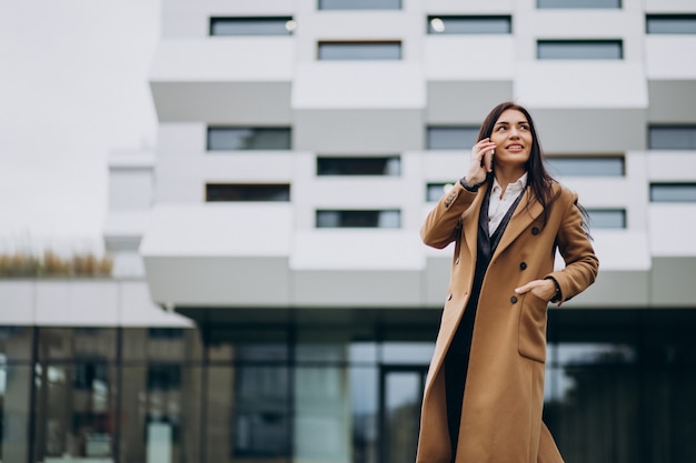 Young business woman using phone