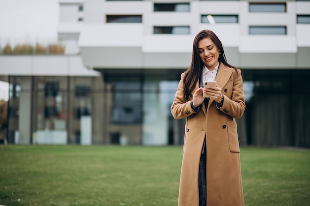 Young business woman using phone