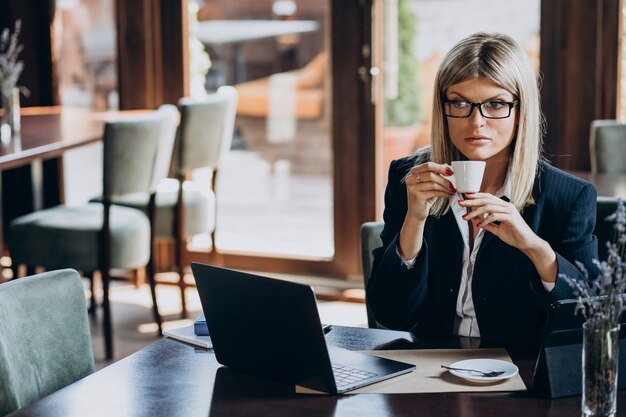 Young business woman working on computer in a cafe