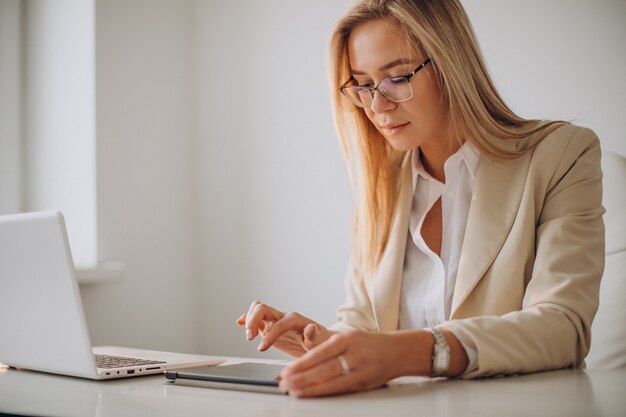 Young business woman working on computer in office