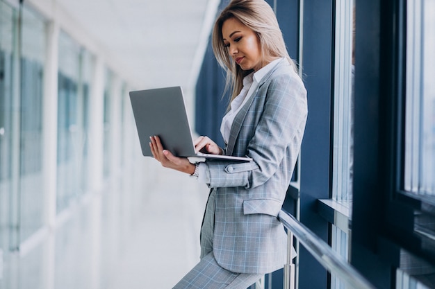 Young business woman working on laptop in a computer