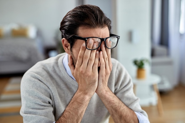 Free photo young businessman feeling exhausted while working at home