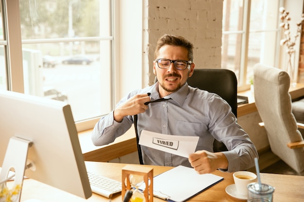 Young businessman fired, looks upset