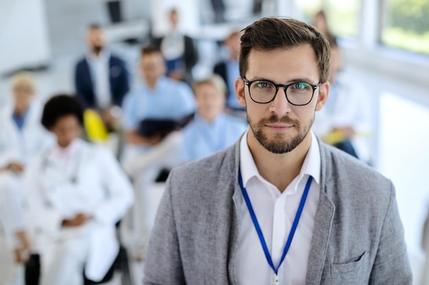 Young businessman giving presentation to group of people in board room