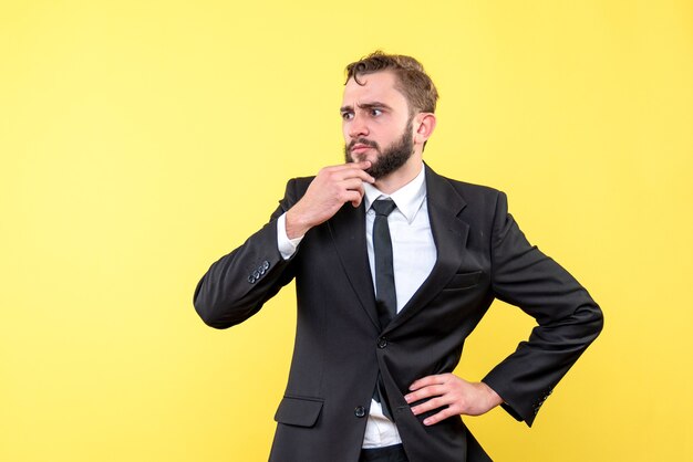 Young businessman lost in thoughts over yellow