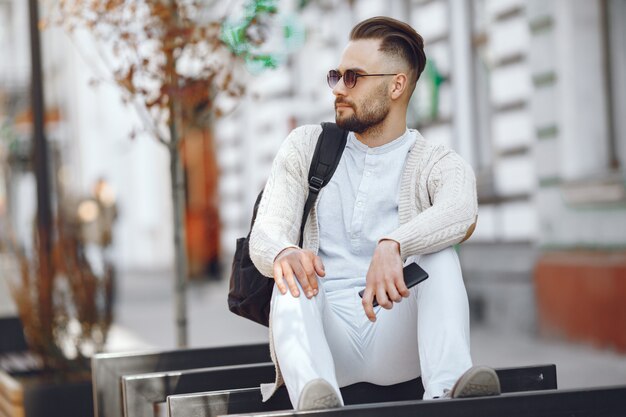 Young businessman sitting on the street