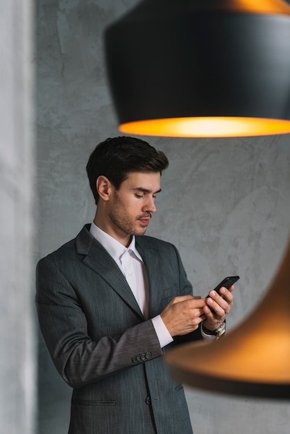 Young businessman in suits using cellphone