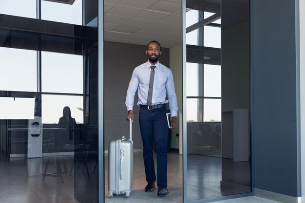 Young businessman waiting for departure in airport, work trip, business lifestyle.