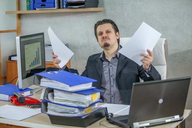 Free Photo young businessman working from his office - the concept of confidence