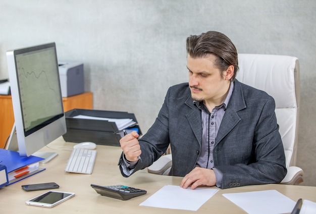 Young businessman working from his office - the concept of hard work