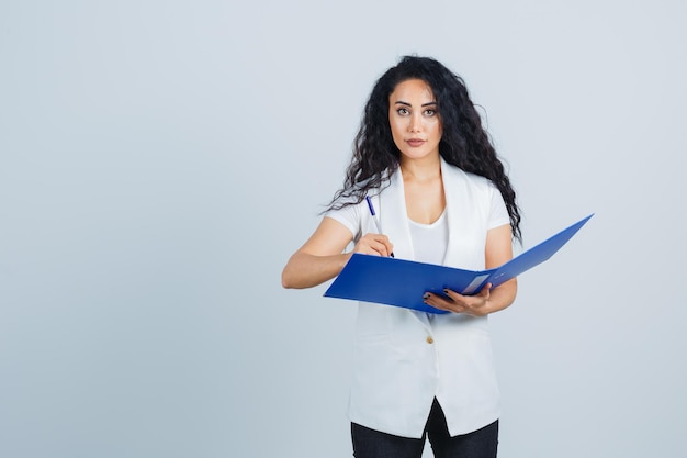 Young businesswoman holding a blue file folder