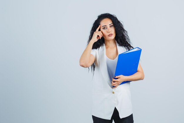 Young businesswoman holding a blue file folder