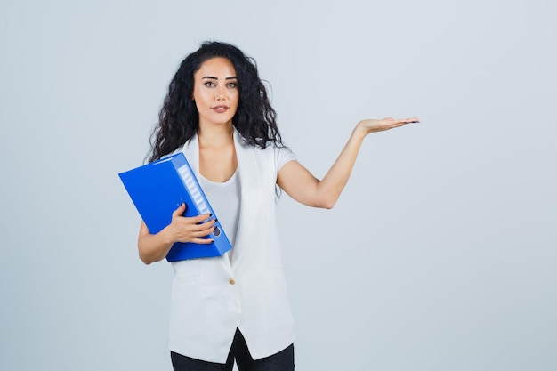 Young businesswoman holding a blue file folder