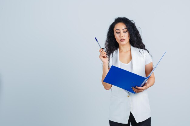 Young businesswoman holding a blue file folder