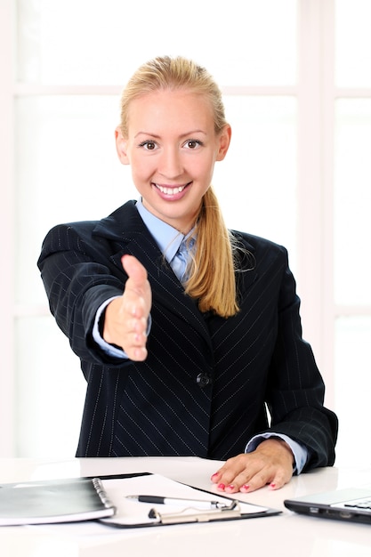 Free Photo young businesswoman offering handshake