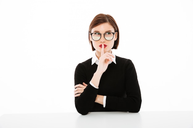 Young businesswoman portrait making the gesture of silence