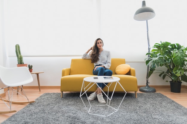 Free photo young businesswoman resting on sofa