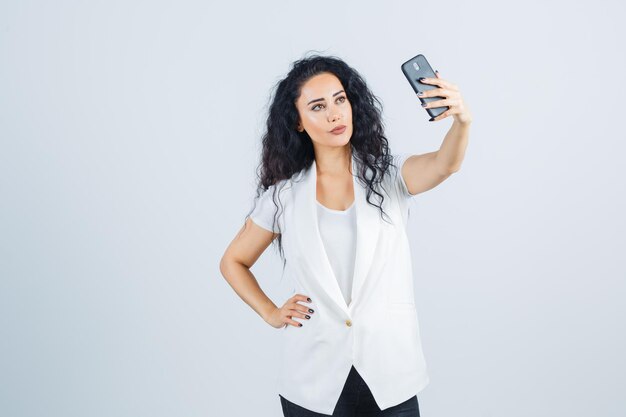 Young businesswoman taking a selfie