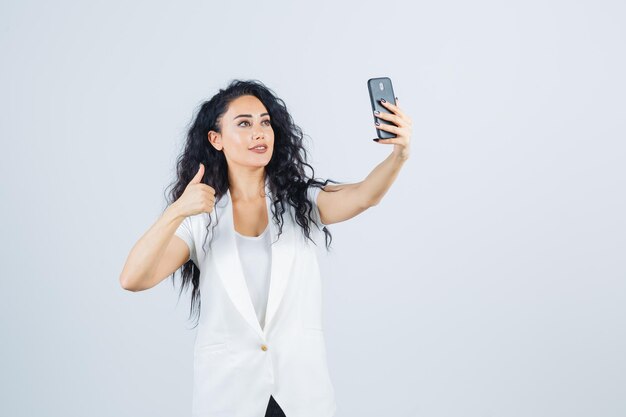 Young businesswoman taking a selfie