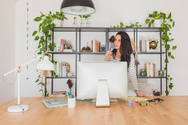 Young businesswoman thinking in the office