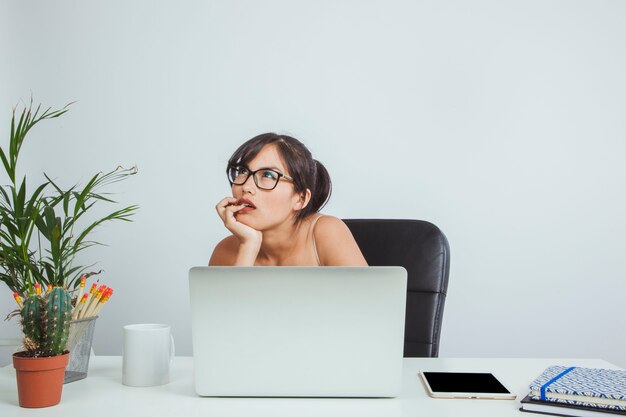 Young businesswoman thinking and working