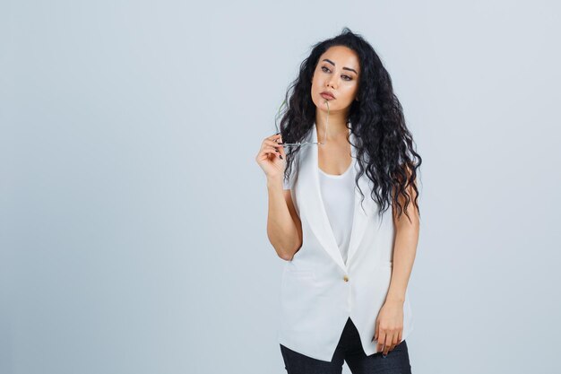 Young businesswoman in a white jacket with eyeglasses