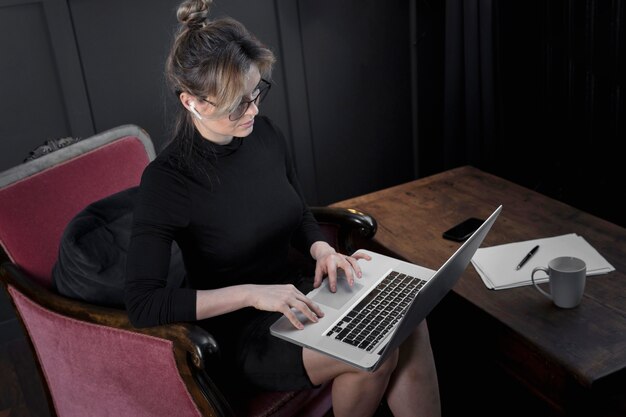 Young businesswoman working on her laptop at the office