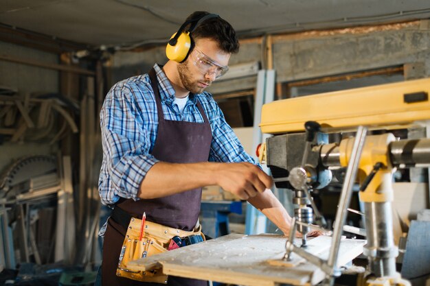 Young carpenter focused on work