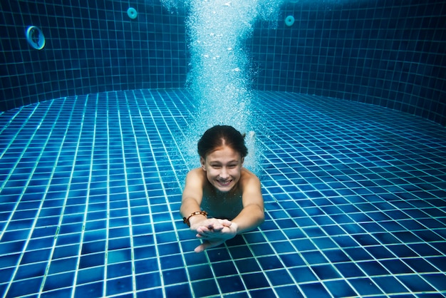 Young caucasian boy enjoying the pool underwater