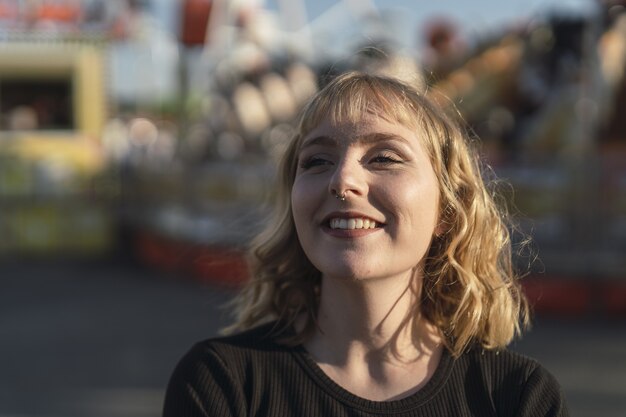 Young Caucasian female spending time at the amusement park