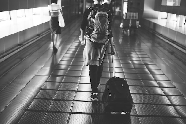 Free Photo young caucasian man travel with luggage in the airport