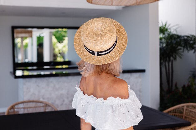 Young caucasian pretty blonde hair woman in outdoor kitchen at villa