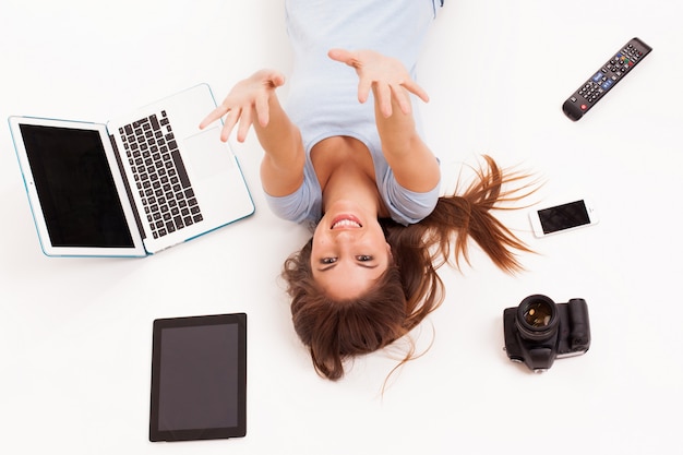 Free Photo young caucasian woman with electronic devices