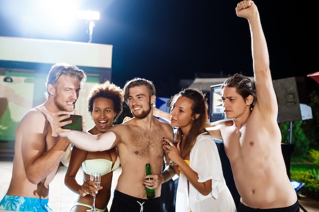 Free Photo young cheerful friends smiling, rejoicing, making selfie, resting at party