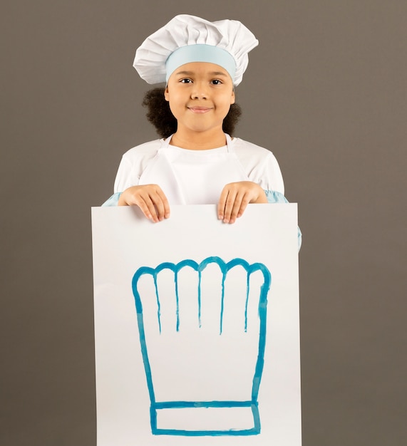 Free photo young chef holding banner front view