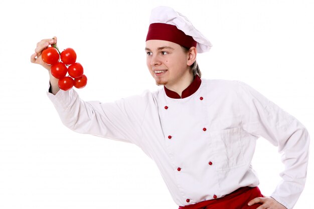 Young chef with tomatoes