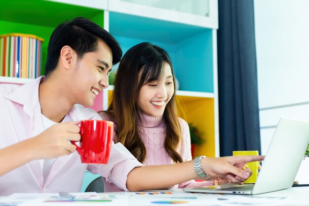 Young colleagues drinking beverage during working