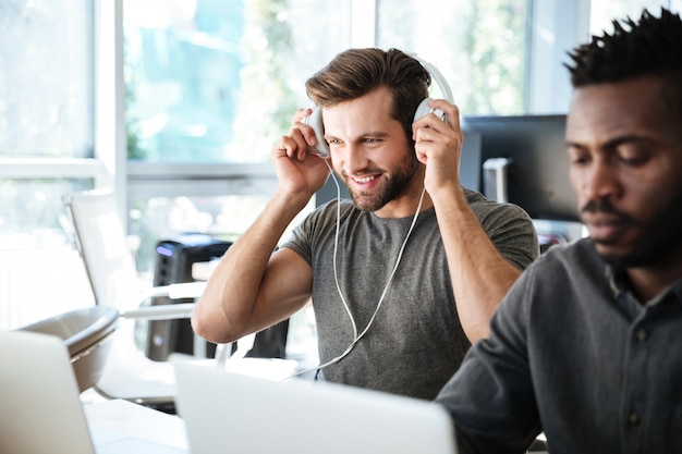 Free Photo young colleagues sitting in office coworking