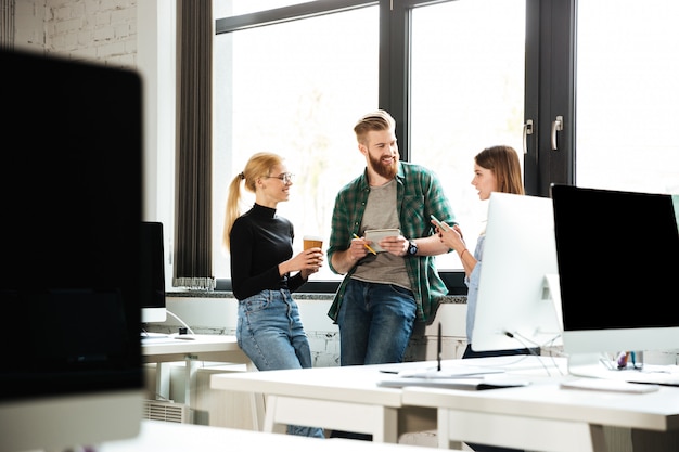 Free Photo young concentrated colleagues in office talking with each other