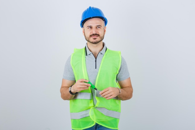 Free photo young construction worker wearing a safety helmet