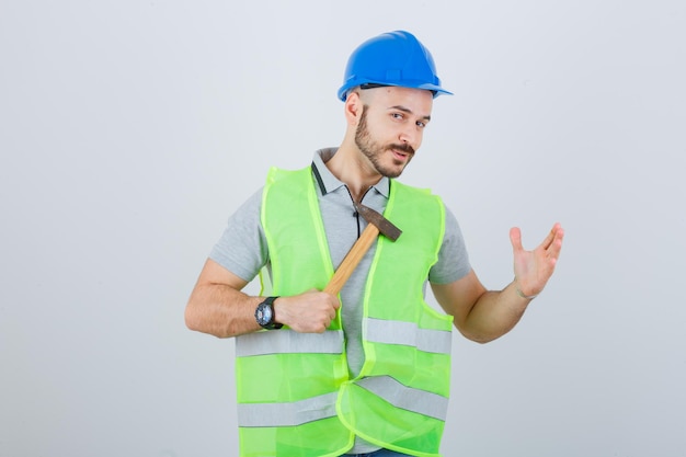 Free Photo young construction worker wearing a safety helmet