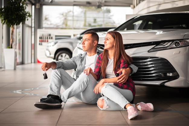 Young couple celebrating new car