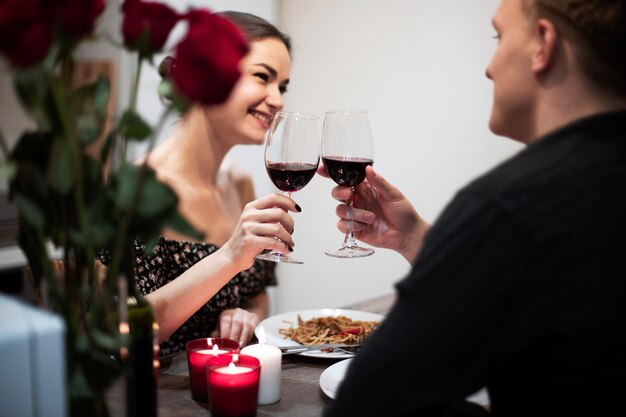 Young couple celebrating valentine's day while having lunch and wine together