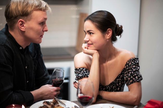 Free photo young couple celebrating valentine's day while having lunch and wine together