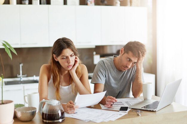 Young couple checking their family budget